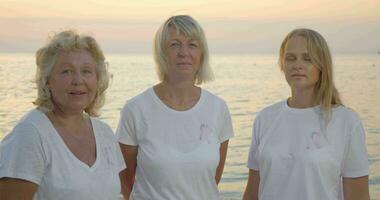 Three women with pink breast cancer awareness ribbons video