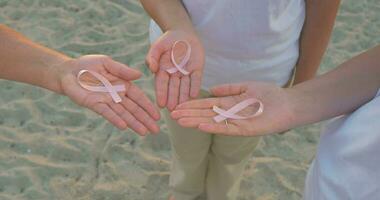 Three Hands Holding Breast Cancer Awareness Ribbon video