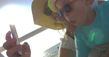 Mom and son taking funny selfie on the yacht video