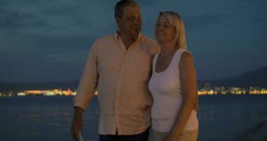 Senior couple on vacation taking cell selfie at night video