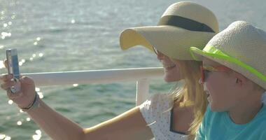 Child and mother making selfie on the ship video