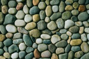 a wall of round stones, smooth neat stones from the shore, boulders photo