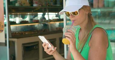 Woman using phone in street on summer day video