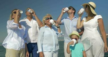 Happy family drinking tea and showing thumbs up outdoor video