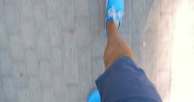 Man walking down the street in blue moccasins video