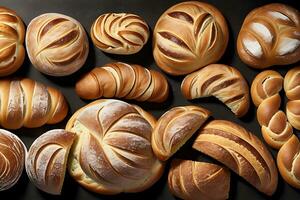 Many kinds of sweet and soft bread top view black background photo