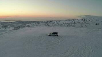 Car drifting on snow, aerial view video