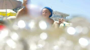 Son and mother waving hands at the seaside video