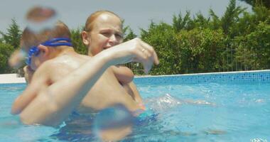 Mother and Son Having Fun in Home Pool video