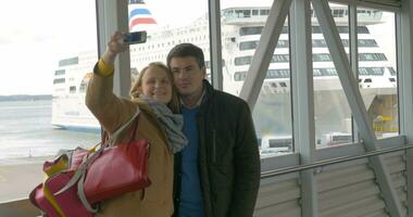 Happy couple making selfie with phone in harbor video