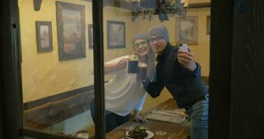 Young hipsters making selfie and drinking beer video