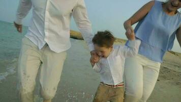 Young Family Running on the Beach video