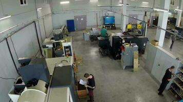 Workers and automatic machines, aerial view video