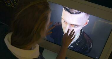 Woman looking at 3D human model on touchscreen monitor video