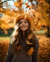 Beautiful young woman in a hat and sweater in the autumn park photo