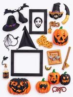 Halloween holiday background. Pumpkins, bats, spiders, witch hat, photo frames, gingerbread cookies on white background