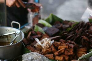 various side dishes, namely tempeh and bacem tofu at roadside sellers. photo