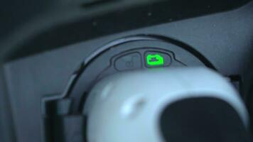 Open - close lid charging, Close up hand man  inserting plug into charging electric car. photo