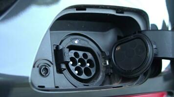 Open - close lid charging, Close up hand man  inserting plug into charging electric car. photo