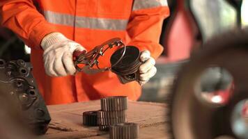 Asia mechanic measuring the piston of an internal combustion engine. Work in a mechanical workshop. photo