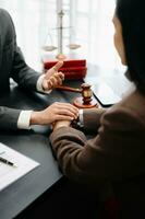 Business people compassionately holding hands and discussing contract papers with laptop and tabletat office photo