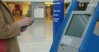 Woman doing self-check in at the airport video