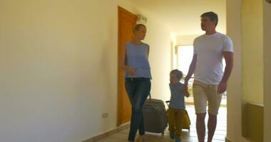 Family Rolling Trolley Bags along the Hotel Passage video