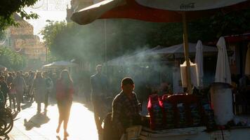 Crowd on sunlit street market video