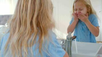 Girl washing face in sink video