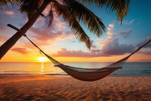 Serene tropical beach scene at sunset with palm trees, a hammock, and soft sand photo