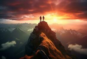 Two people helping each other on a mountain top photo