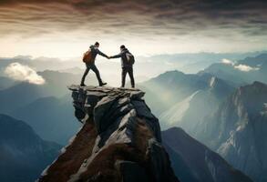 Two people helping each other on a mountain top photo