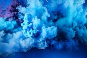 Abstract blue powder splattered background showcasing a vibrant colored cloud bursting forth like a Holi paint explosion photo