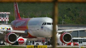 PHUKET, THAILAND NOVEMBER 26, 2016 - VietJet Air Airbus A320 taxiing on the runway before departure at Phuket International airport. Tourism and travel concept video