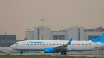 MOSCOW, RUSSIAN FEDERATION JULY 28, 2021 - Lowcost Boeing 737 of Pobeda taxiing on the runway at Sheremetyevo airport SVO. Tourism and travel concept, air flight video