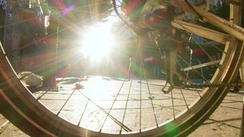 People walking behind bicycle wheel video