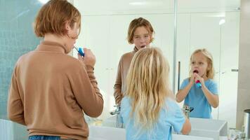 Siblings brushing teeth together video