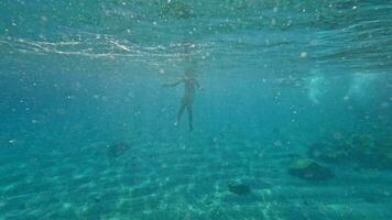 Teenager swimming underwater video