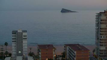 Evening beach scene of Benidorm with island in the sea video