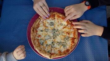 Hands taking pizza slices from the plate video