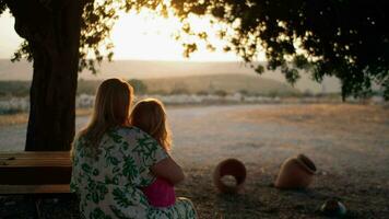 Mother and little child in the country at sunset video