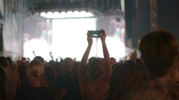 Young audience at night concert outdoor video