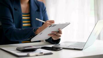 Close up of businesswoman or accountant hand typing laptop working to calculate on desk about cost at  office. video