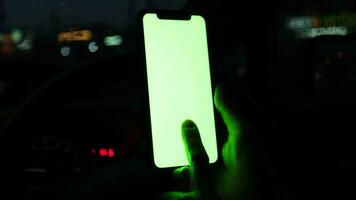 Using phone at car in city night video