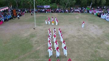 Gorontalo, Indonesia - August 17, 2023 - Aerial view of the elderly acted as officers of the Indonesian independence ceremony. The Indonesian flag lowering ceremony witnessed by villagers video