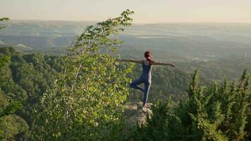 Yoga trainieren von weiblich Athlet. jung gesund Frau tun Yoga im das Berge während Sonnenaufgang. Wohlbefinden und gesund Lebensstil, Zen Konzept. schleppend Bewegung. video