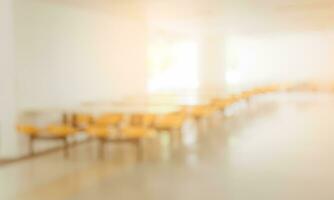 Blurred image background of empty seats and tables in the clean cafeteria or canteen photo