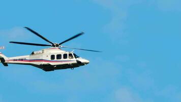 SOCHI, RUSSIA AUGUST 04, 2022 - Russian Mi 8 helicopter flies in the blue sky at Sochi airport, long shot video