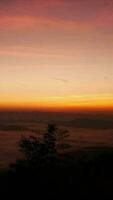 Morning landscape. sun rises over mountains and fog. video time lapse.