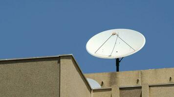 Satellite dish on the roof providing TV signal reception video